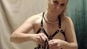 french slave straps into harness for bound submission session