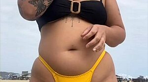 Young african usa girl in tight yellow bikini splitting swollen pussy on beach