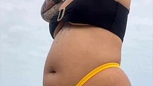 Young african usa girl in tight yellow bikini splitting swollen pussy on beach