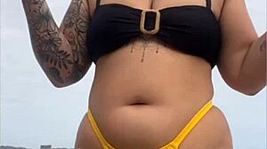 Young african usa girl in tight yellow bikini splitting swollen pussy on beach