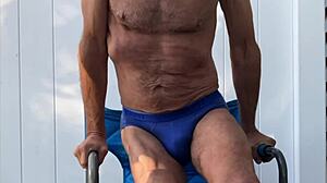 skinny legs stretch deep in blue briefs on chair