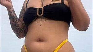 Young african usa girl in tight yellow bikini splitting swollen pussy on beach