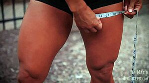 tia marie flexes her muscular biceps during measurements