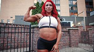 tia marie flexes her muscular biceps during measurements