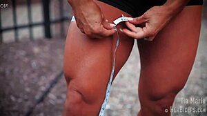 tia marie flexes her muscular biceps during measurements