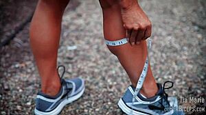 tia marie flexes her muscular biceps during measurements