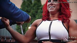 tia marie flexes her muscular biceps during measurements