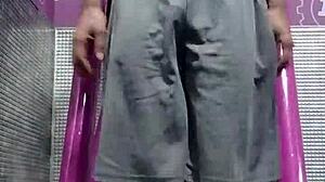 athletic brunette uses gym machine for intense solo workout