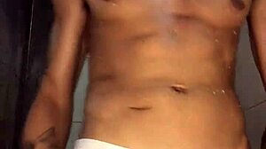 young hunk strokes massive cock under hot shower spray