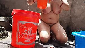 Village bhabhi secretly flashes big boobs and pussy in outdoor bath