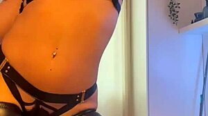 tattooed brunette slips into leather lingerie dances sexy then orgasms hard on huge dildo