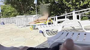 Milf grabs big cock for handjob by public pool leading to massive outdoor cumshot