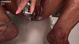 her plump curves glisten as she fingers her big clit to a soaking wet orgasm in the shower