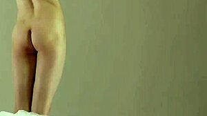 blonde gymnast stretches in flexible acrobatic gymnastics routine