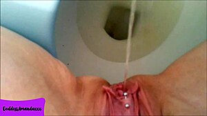 Shaved Pierced Pussy Pees in Bathroom Close-Up