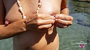 nippleringlover pisses nude on beach spreading pierced pussy wide