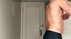 suggestive sexy guy shaves smooth in black beach shorts