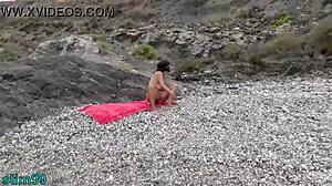 WATCH THIS NUDE MATURE SLUT INSERT STONE IN ASS AND PUSSY ON NUDIST BEACH!