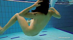 Kristy shakes massive boobs wildly. Hot babe dives deep underwater in steamy pool action