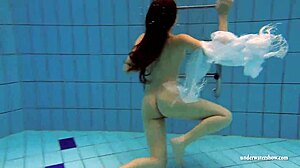 Kristy shakes massive boobs wildly. Hot babe dives deep underwater in steamy pool action