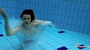 Kristy shakes massive boobs wildly. Hot babe dives deep underwater in steamy pool action