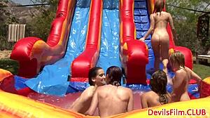 Close-up wet lesbians scissor and strap-on fuck during outdoor orgy