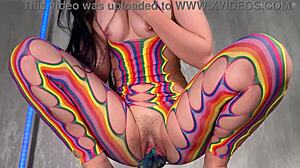 Petite brunette student bends over in rainbow body stocking fucking wet pussy with huge alien dildo close up