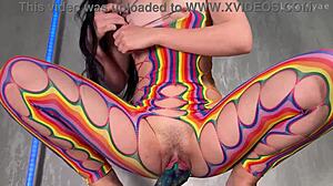 Petite brunette student bends over in rainbow body stocking fucking wet pussy with huge alien dildo close up
