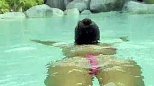 Monika Fox's huge fake tits spill from pink bikini at poolside strut