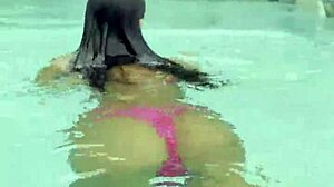 Monika Fox's huge fake tits spill from pink bikini at poolside strut