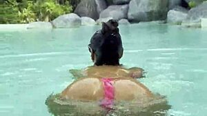Monika Fox's huge fake tits spill from pink bikini at poolside strut