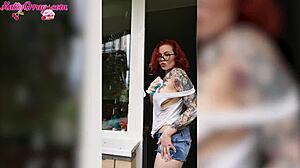 Redhead babe washes windows wearing wet t-shirt at home