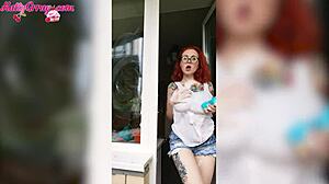 Redhead babe washes windows wearing wet t-shirt at home