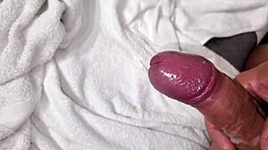 Man in towel strokes hard with close up finish