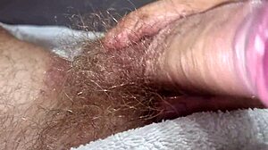 Man in towel strokes hard with close up finish